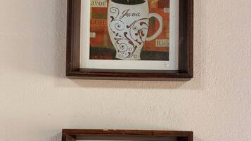 Two framed pictures of coffee cups on a wall.