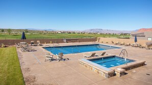 A pool area with two pools, lounge chairs, and a view of mountains. - The Approach Shot: 4  BR, 4  BA House in St. George, Sleeps 10 (St. George)