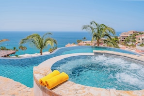 A pool with a hot tub, surrounded by palm trees and a view of the sea. - Stunning 8BR Cabo Villa with Butler & Cooking Services (Cabo San Lucas)