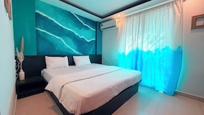 A bedroom with a bed, a wall-mounted air conditioner, and a window with curtains.