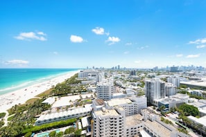 A coastal cityscape with a beach, high-rise buildings, and a clear sky. - Ocean View Private Residence at The Setai - 3006 (Miami Beach)