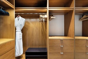 A wooden walk-in closet with hanging space, drawers, and a step for easy access. - Ocean View Private Residence at The Setai - 3006 (Miami Beach)