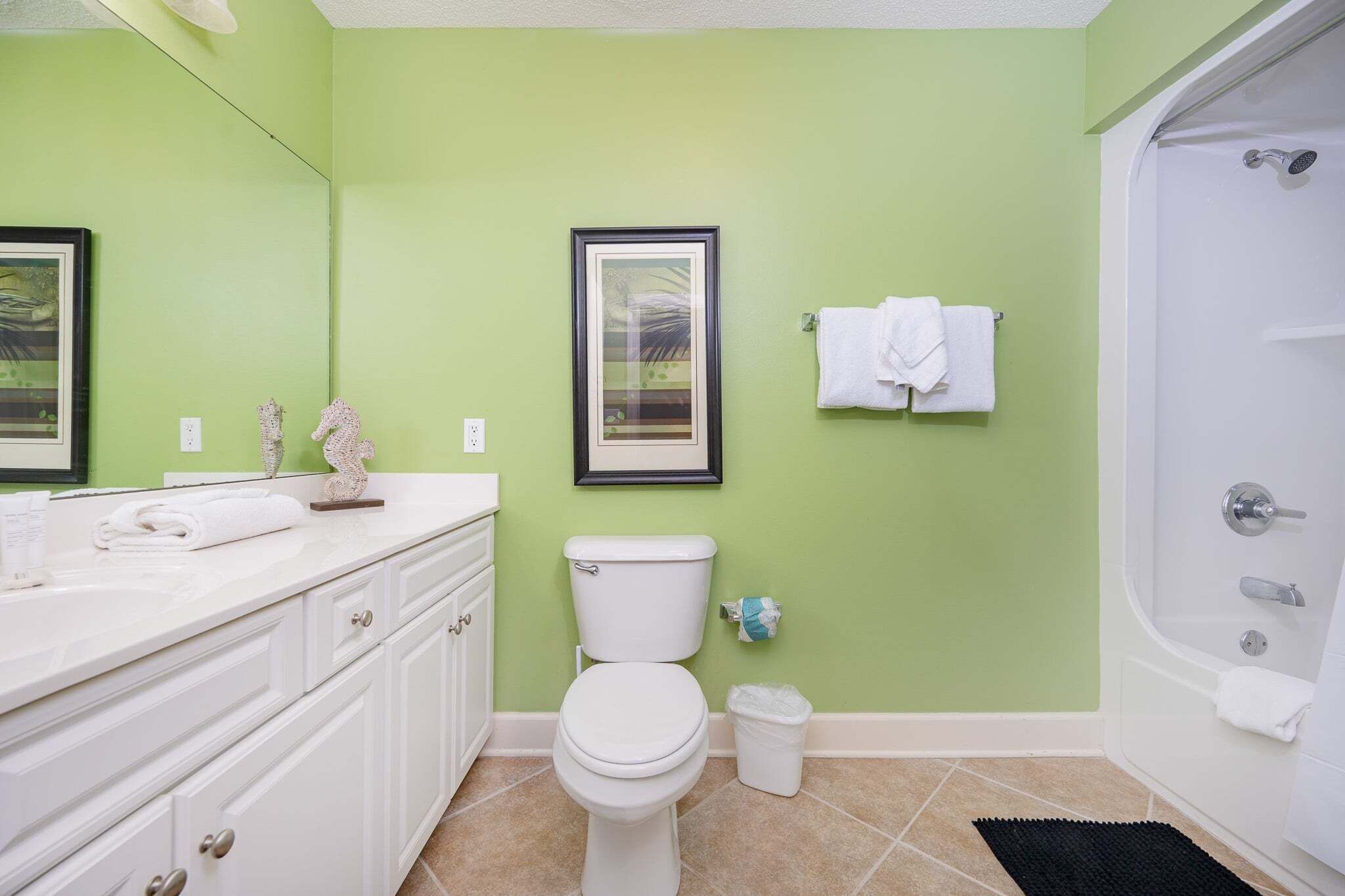 A bathroom with a toilet, sink, and bathtub.