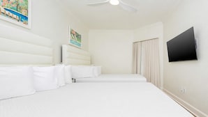 A hotel room with a large bed, a flat-screen TV, and a ceiling fan. - The Oasis 1008 Formerly Phoenix West Ii 1008 3 Bedroom Condo (Orange Beach)