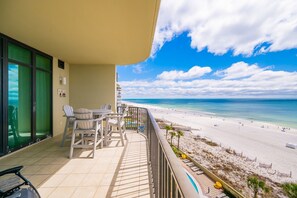 A balcony with a view of a beach and ocean. - Phoenix West 604 3 Bedroom Condo (Orange Beach)