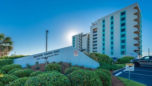 A multi-story hotel named 'Island Winds East' at 333 West Beach Blvd. with a private parking sign and a security notice. - Island Winds East 307 2 Bedroom Condo (Gulf Shores)