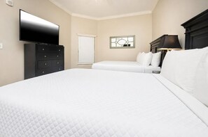 A hotel room with a large bed, a TV, a dresser, and a window with a view. - The Oasis 2410 Formerly Phoenix West Ii 2410 3 Bedroom Condo (Orange Beach)