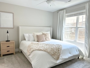 A bedroom with a bed, a nightstand, a ceiling fan, and a window with curtains. - Newly Remodeled Condo Minutes to UA w/ 2 King Beds & Brand New Furniture (Tuscaloosa)