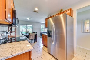 A kitchen with a stainless steel refrigerator, a microwave, and a built-in oven. - 6 Mi to Dtwn! Centrally Located Sarasota Home (Sarasota)