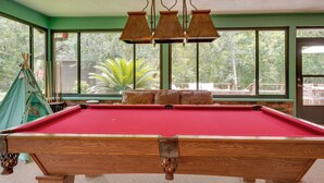 A pool table with a red felt surface, surrounded by green walls and large windows. - 2 Mi to Silver Springs State Pk! Family Hideaway (Silver Springs)