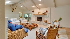 A spacious living room with a fireplace, white sofas, a coffee table, and a ceiling fan. - 2 Mi to Silver Springs State Pk! Family Hideaway (Silver Springs)