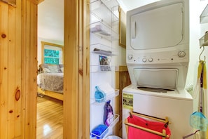 A laundry room with a washing machine, drying rack, and shelves with various items. - Near Beaches & Golf! All-seasons Gem in N Monmouth (North Monmouth)