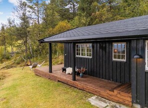A wooden cabin with a porch, a fire pit, and outdoor seating. - Cozy mountain cabin at 962m (Ål)