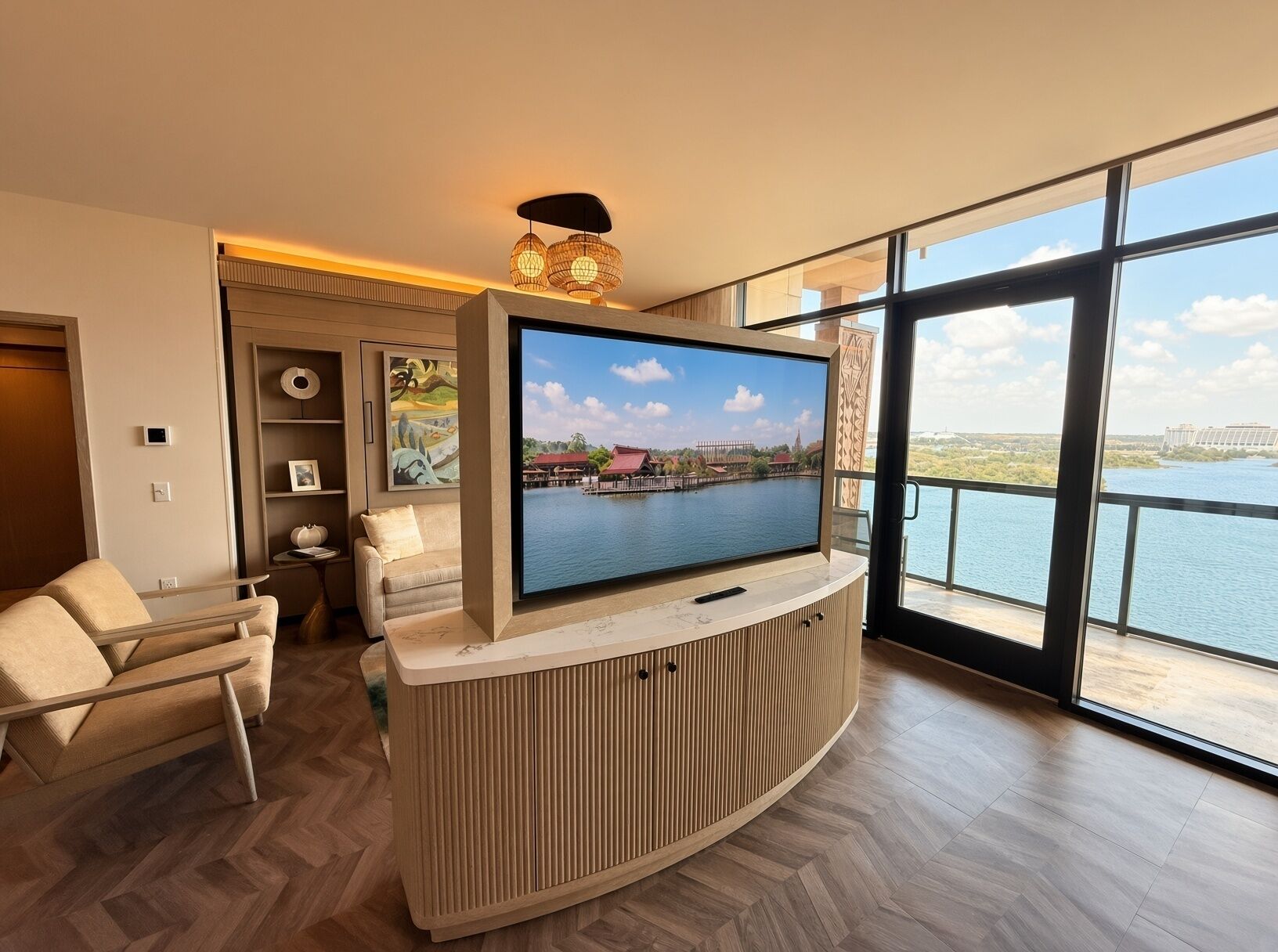 A modern living room with a large flat-screen TV, a sofa, and a dining table.