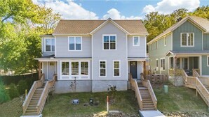 A two-story residential building with a front porch and a small front yard. - 3-bedroom 2.5-bathroom house walking distance from the campus and Dixon with AC (Fayetteville)