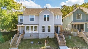 A two-story residential building with a front porch and a small front yard. - 3-bedroom 2.5-bathroom house walking distance from the campus and Dixon with AC (Fayetteville)