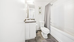 A bathroom with a toilet, sink, and shower. - Founder's Club York - 3 Bedroom Condo  (Toronto)
