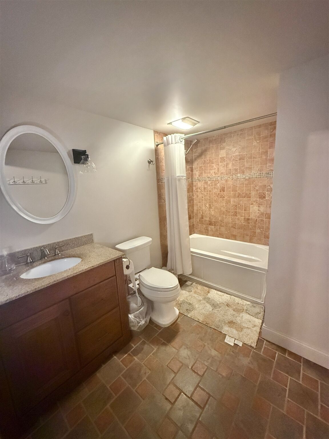 A bathroom with a sink, toilet, and bathtub.