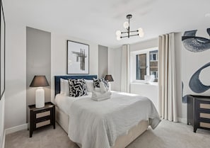 A modern bedroom with a large bed, bedside tables with lamps, a ceiling light fixture, and a window with curtains. - Beautiful modern flat, opposite Ascot Racecourse - Pass the Keys (Ascot)