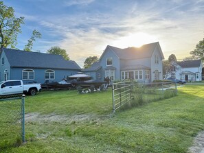 A residential area with houses, a white pickup truck, and a boat trailer. - Your Lake Escape Starts at Balti Bay Lodge New Baltimore 3 bedroom, Boat Parking (New Baltimore)