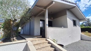 A modern two-story house with a covered porch, a small front yard, and a number '27' sign. - Villa on the outskirts of Geneva, between the lake and the mountains (Douvaine)