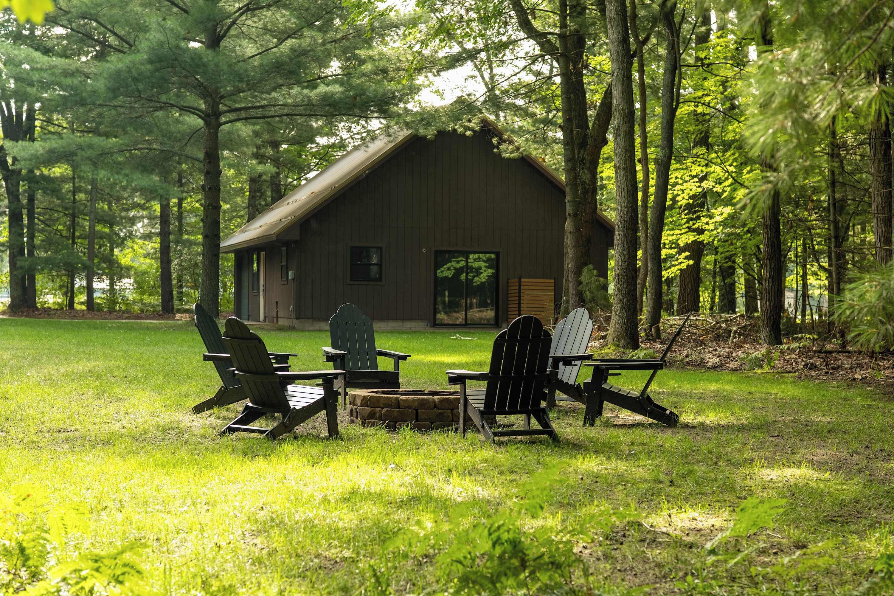 A rustic wooden cabin surrounded by a lush green forest.