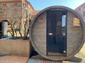 Una construcció de fusta gran, amb una porta, una petita finestra i una placa de fusta.