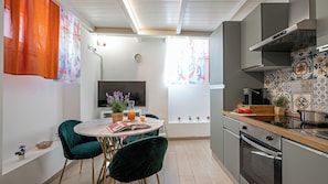 A modern kitchen with a built-in oven, a coffee machine, and a wooden countertop. - Italianway Easy - Angelo della Pergola 7 A (Milan)