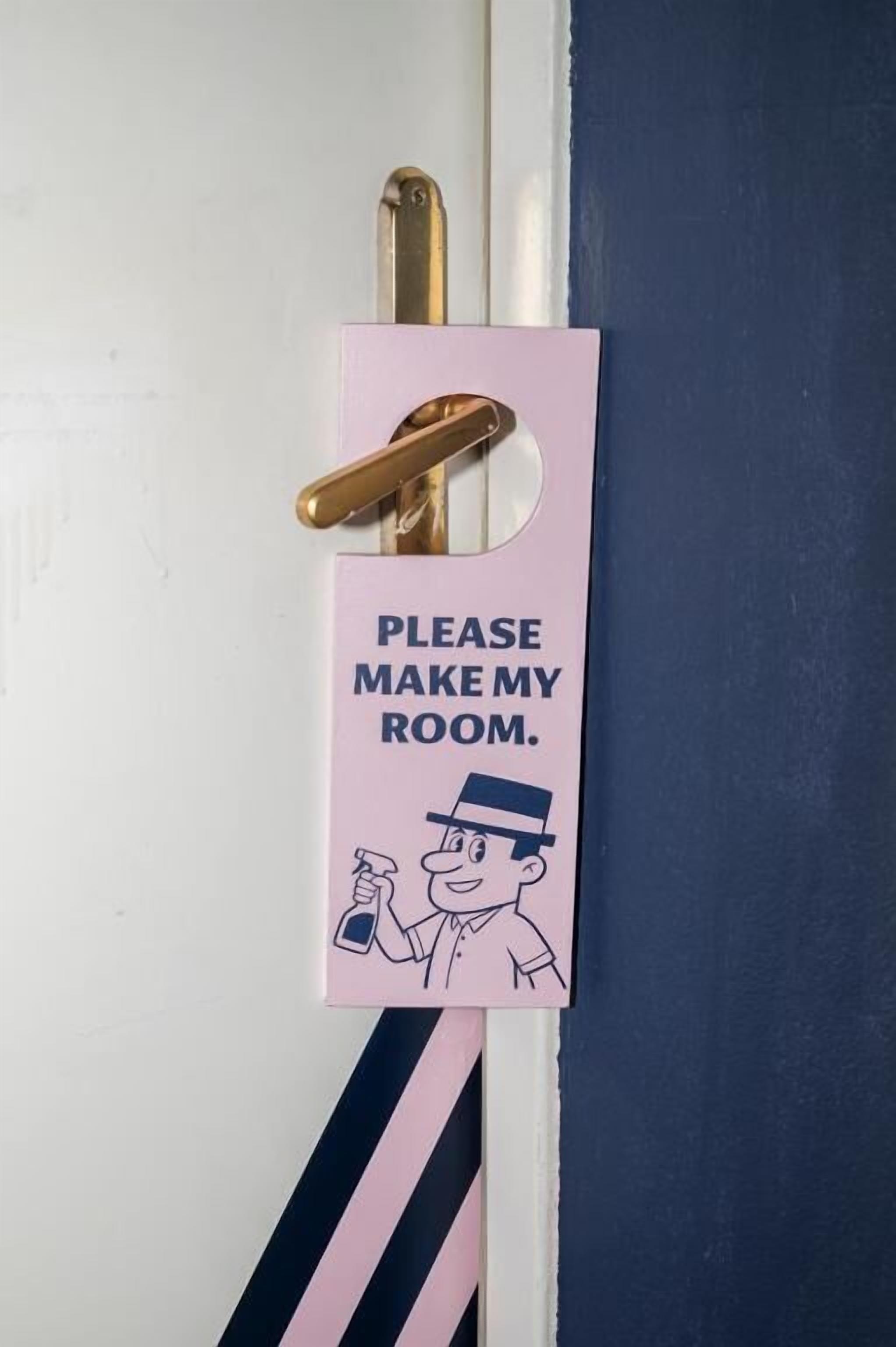 A door with a sign that reads 'PLEASE MAKE MY ROOM.'