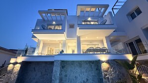 A modern multi-level residential building with a waterfall feature at the front. - Nerja Paradise Rentals - Villa Barranco (Nerja)