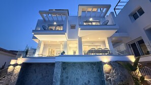 A modern multi-level residential building with a waterfall feature at the front. - Nerja Paradise Rentals - Villa Barranco (Nerja)