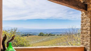A view from a window overlooking a hilly landscape with a clear sky. - Farmhouse with pool between Orvieto and Todi (Montecchio)