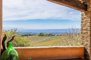 A view from a window overlooking a hilly landscape with a clear sky. - Farmhouse with pool between Orvieto and Todi (Montecchio)