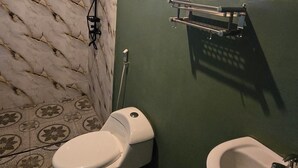 A bathroom with a toilet, a sink, and a shower.