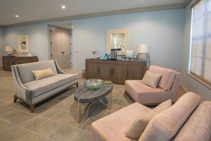 A living room with two sofas, a coffee table, and a cabinet. - Inviting Room w/ Spacious Living Room, Balcony, and Onsite Pool Near Key Largo (Duck Key)