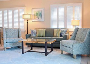 A living room with a sofa, two armchairs, a coffee table, and a floor lamp. - Full Kitchen for Homemade Meals and a Tropical Pool Just Outside your Door (Duck Key)