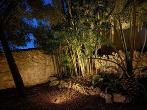 A garden area with a stone wall, trees, and a variety of plants. - Son Idò by Rentallorca Mallorcan essence amidst the gardens (Muro)