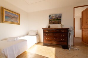 A bedroom with a bed, a dresser, and two paintings on the wall. - Son Idò by Rentallorca Mallorcan essence amidst the gardens (Muro)