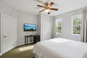 A bedroom with a bed, a desk, a television, and a ceiling fan. - Epic Reunion Resort Escape - Near Disney & Heritage Pool (Kissimmee)