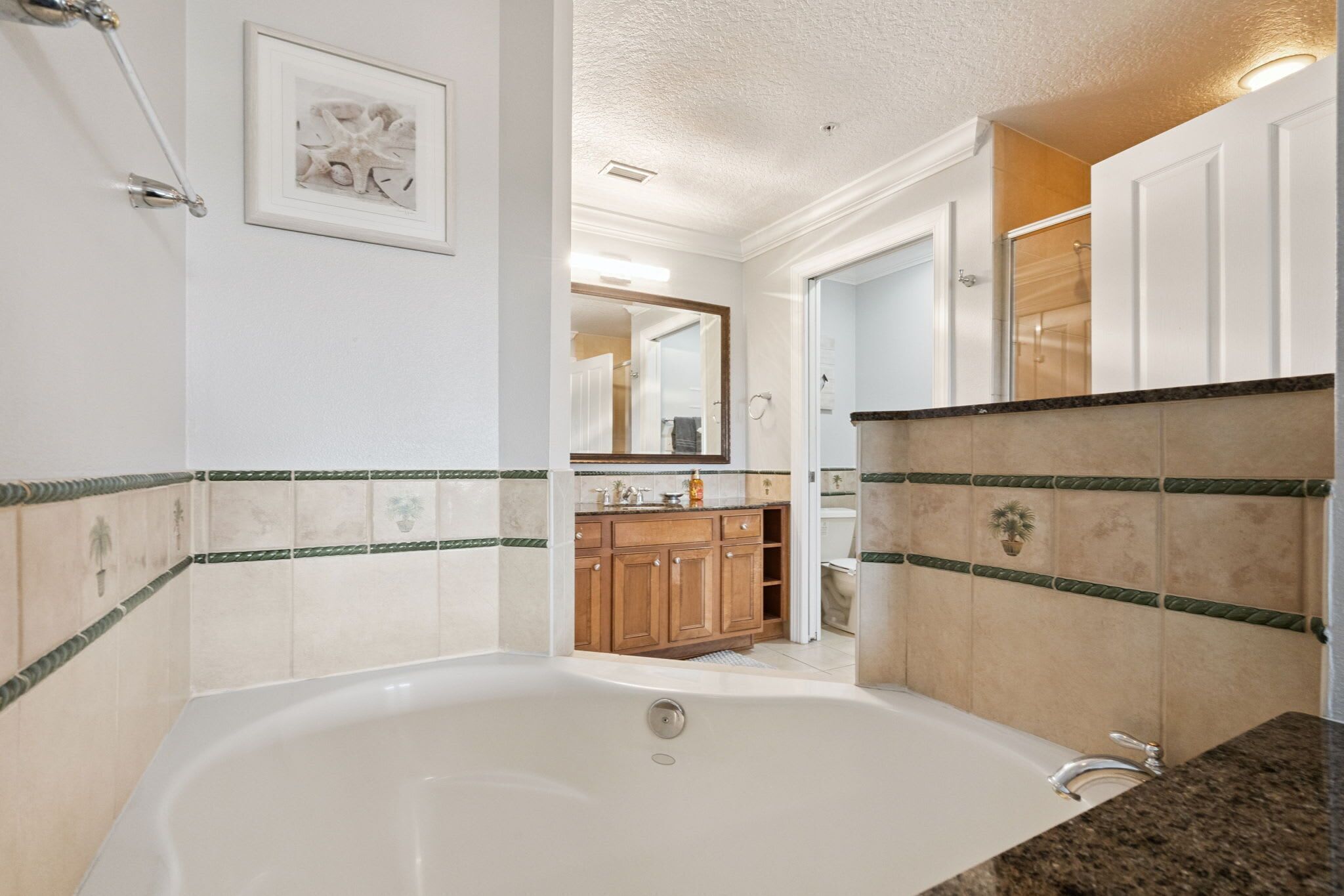 A bathroom with a bathtub, a sink, and a mirror.