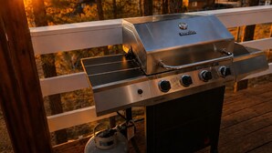 A Char-Broil gas grill on an outdoor deck with a wooden railing. - Big Bear Escape: Cozy Fireplace! Dine Al Fresco! (Big Bear City)