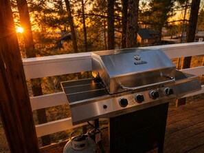 A Char-Broil gas grill on an outdoor deck with a wooden railing. - Big Bear Escape: Cozy Fireplace! Dine Al Fresco! (Big Bear City)
