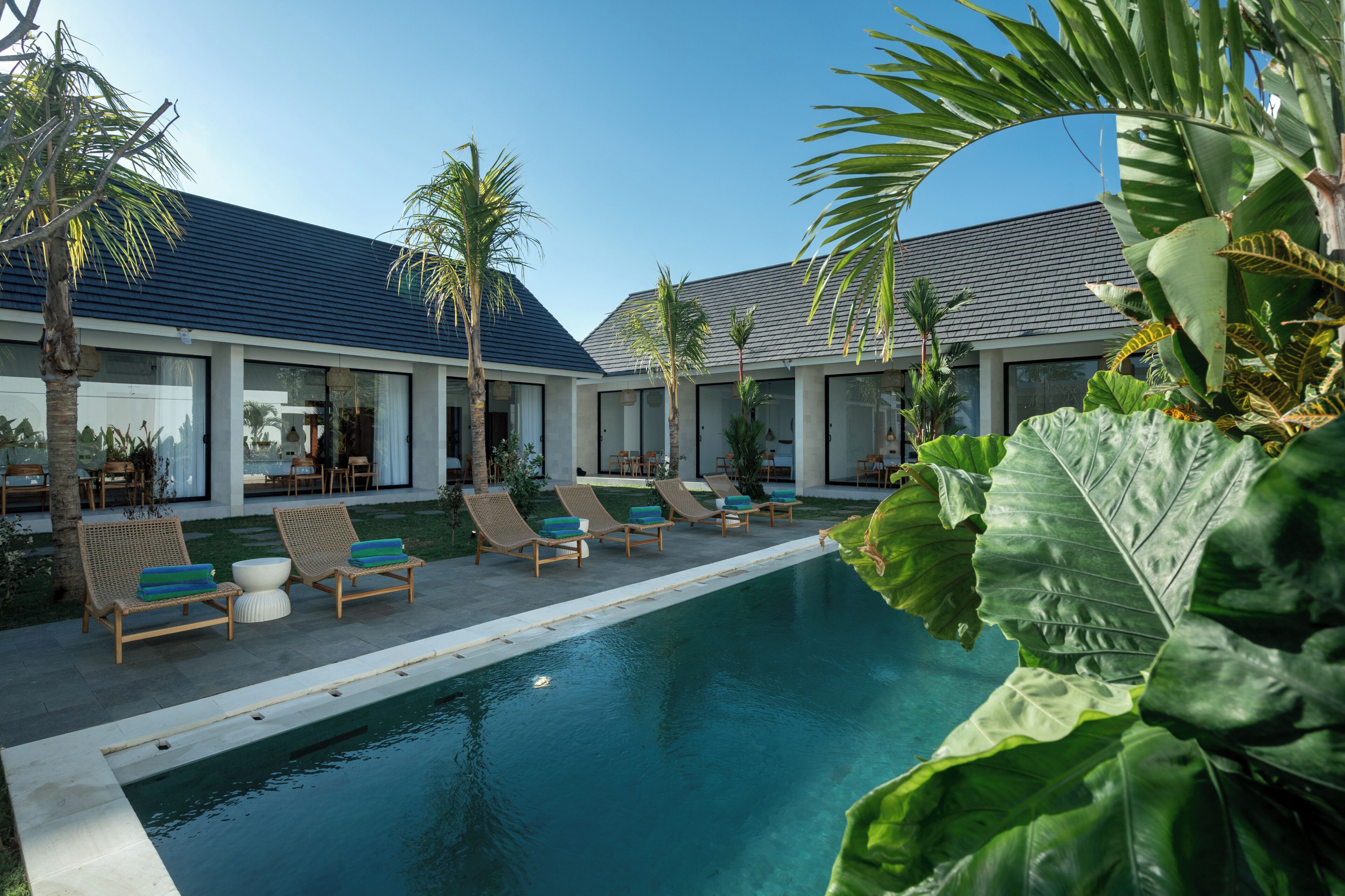 A poolside area with lounge chairs and a swimming pool.