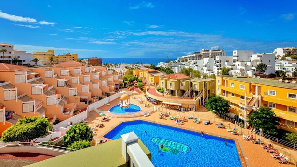A resort with multiple swimming pools, a beach area, and a view of the sea. - 1bedroom ocean view apartment (Costa Adeje)