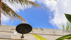 Eine Steinmauer mit einer Solaranlage und einem Wasserhahn.