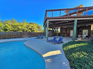 A pool with lounge chairs, a covered patio area, and a wooden deck. - The Lookout: North Cape, 3 Bedrooms, Pet-Friendly, Private Pool! Short walk to b (Cape San Blas)