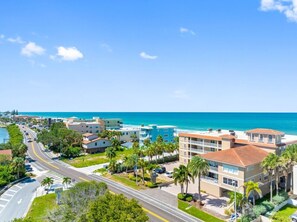 A coastal hotel with multiple buildings, a road, and a view of the ocean. - Ocean Side Beach Front Penthouse! (Indian Rocks Beach)