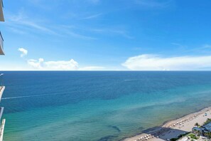 A coastal view with a clear sky, a sandy beach, and a calm sea. - Waterfront Oasis With Resort Amenities (Hollywood)