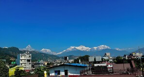 A mountainous landscape with a clear blue sky.