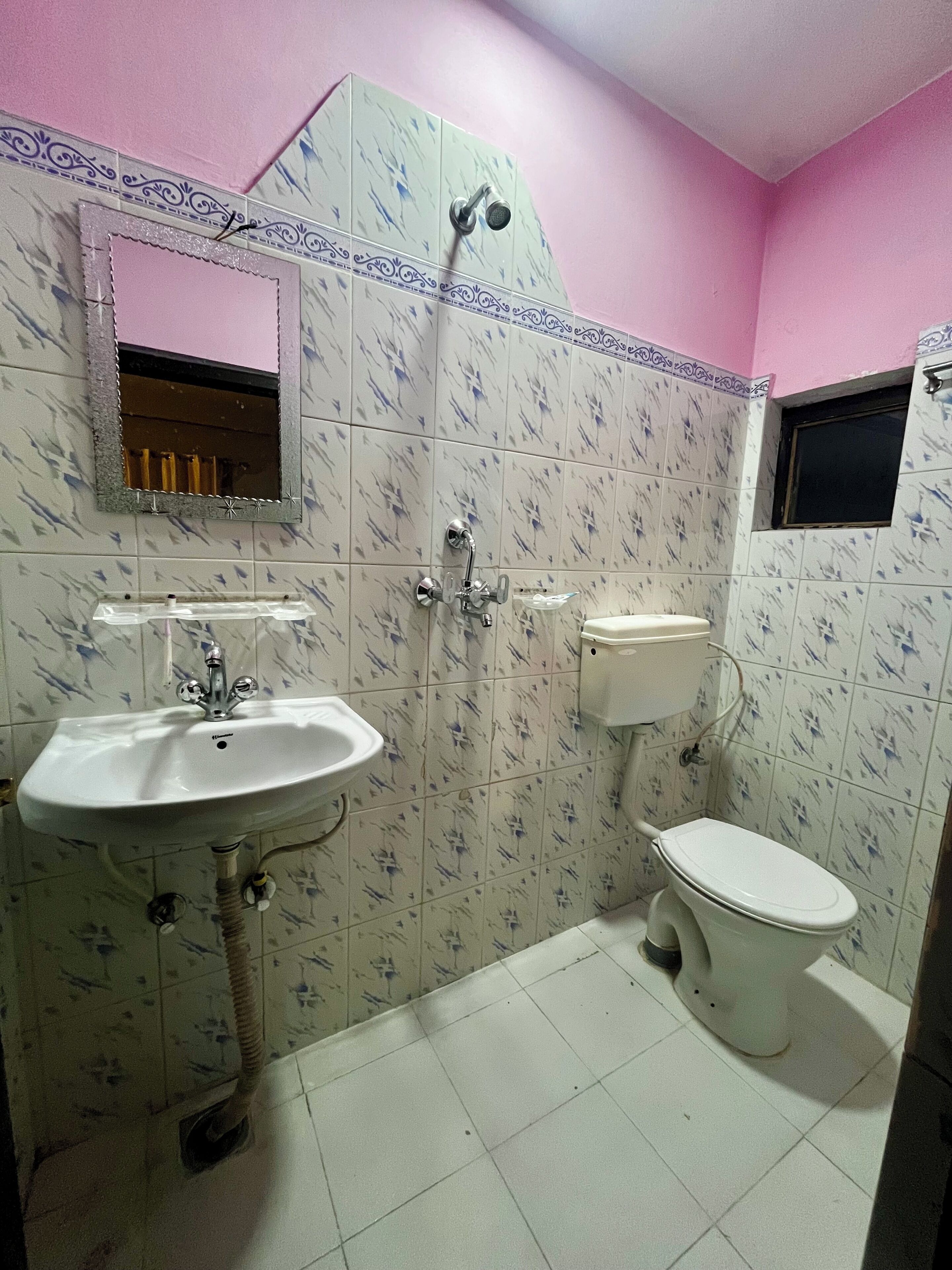 A bathroom with a sink, toilet, and shower.